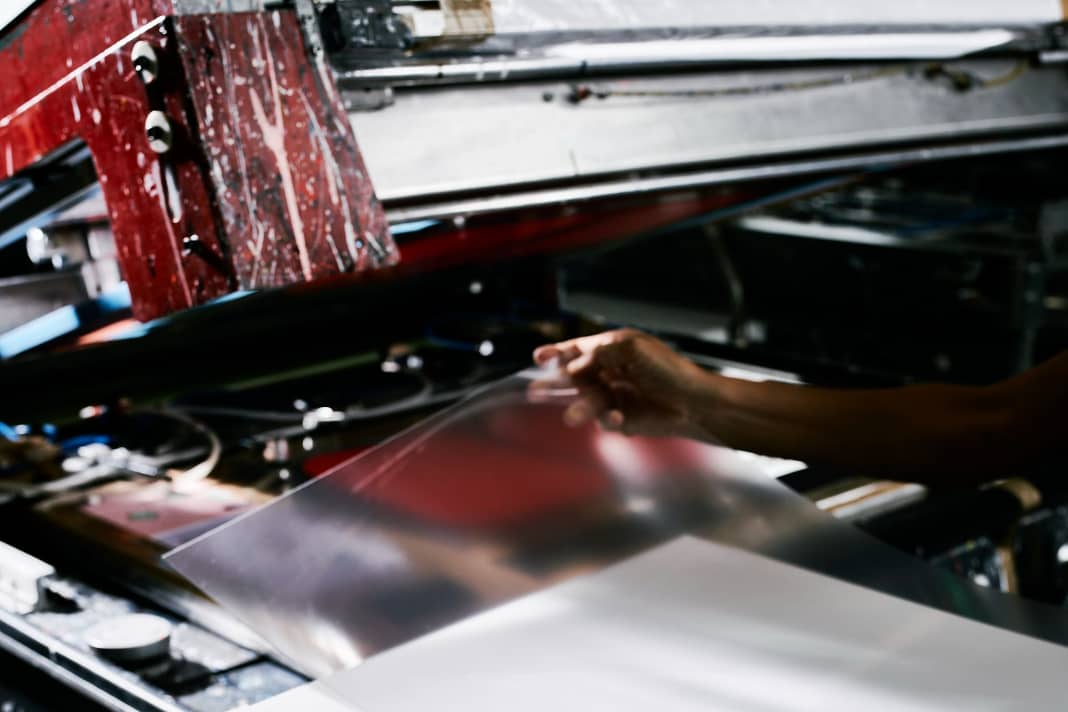 The production process starts with a film blank. This is placed in a press by hand