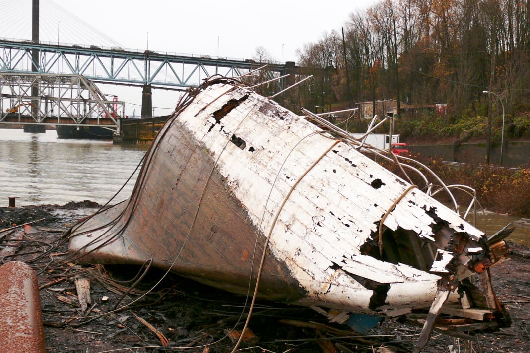 After the salvage operation, the hull of the once proud twelve-person vessel lies on land like a beached whale