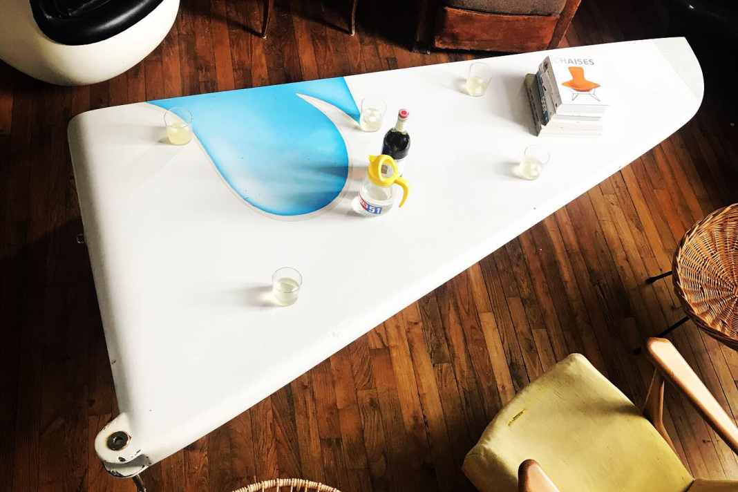 Cheers! This table used to be a part of the fuselage, more precisely the prow of "Geronimo".