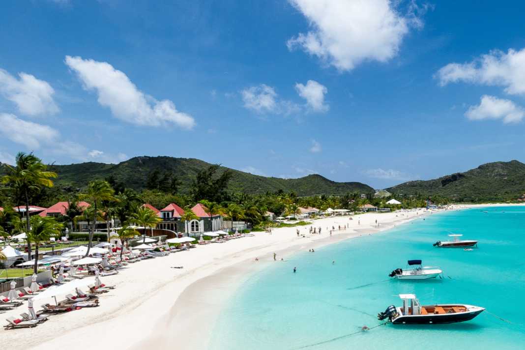 A real dream beach plus boats bobbing in front of it.
