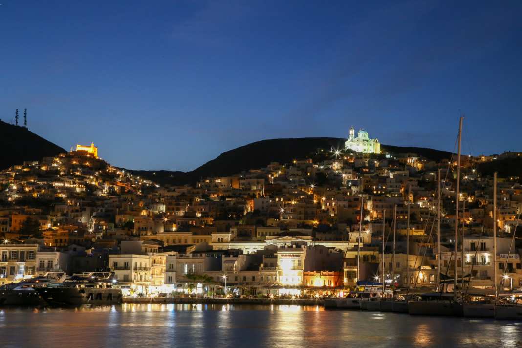 The illuminated main town of the island of Syros, Ermoupoli - pure romance despite the busy ferry traffic.