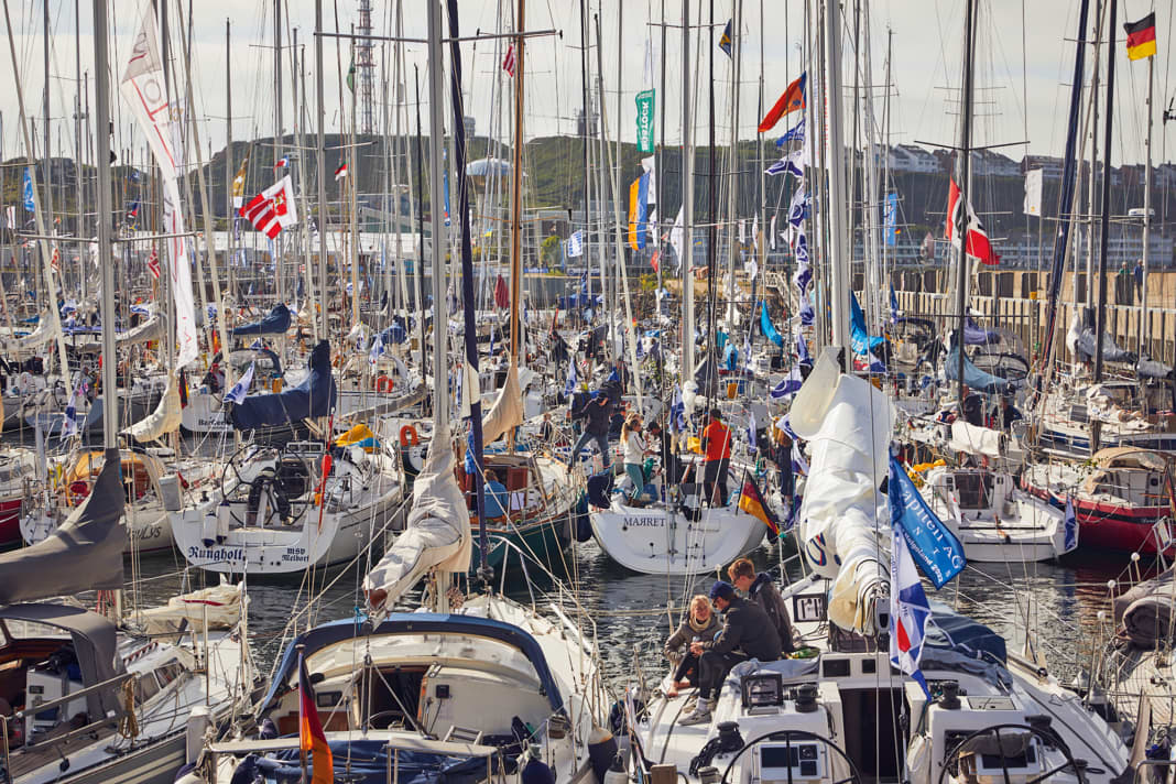 Heligoland harbour: during the North Sea Week, the basin is occupied by the numerous participating yachts. During the day, the crews sail around the red rock, and in the evening, the party goes wild