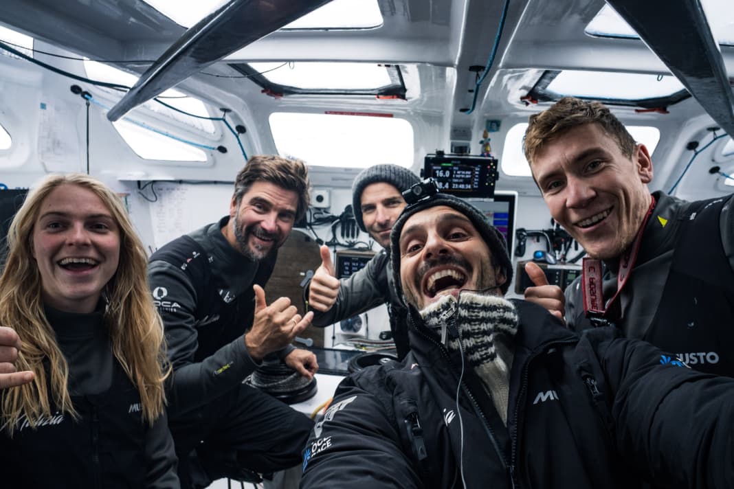 Team Malizia célèbre sa deuxième place à mi-parcours de l'étape reine (de droite à gauche) : Le co-skipper Will Harris, le journaliste à bord Antoine Auriol, le navigateur Nico Lunven, le skipper Boris Herrmann et la Néerlandaise Rosalin Kuiper.
