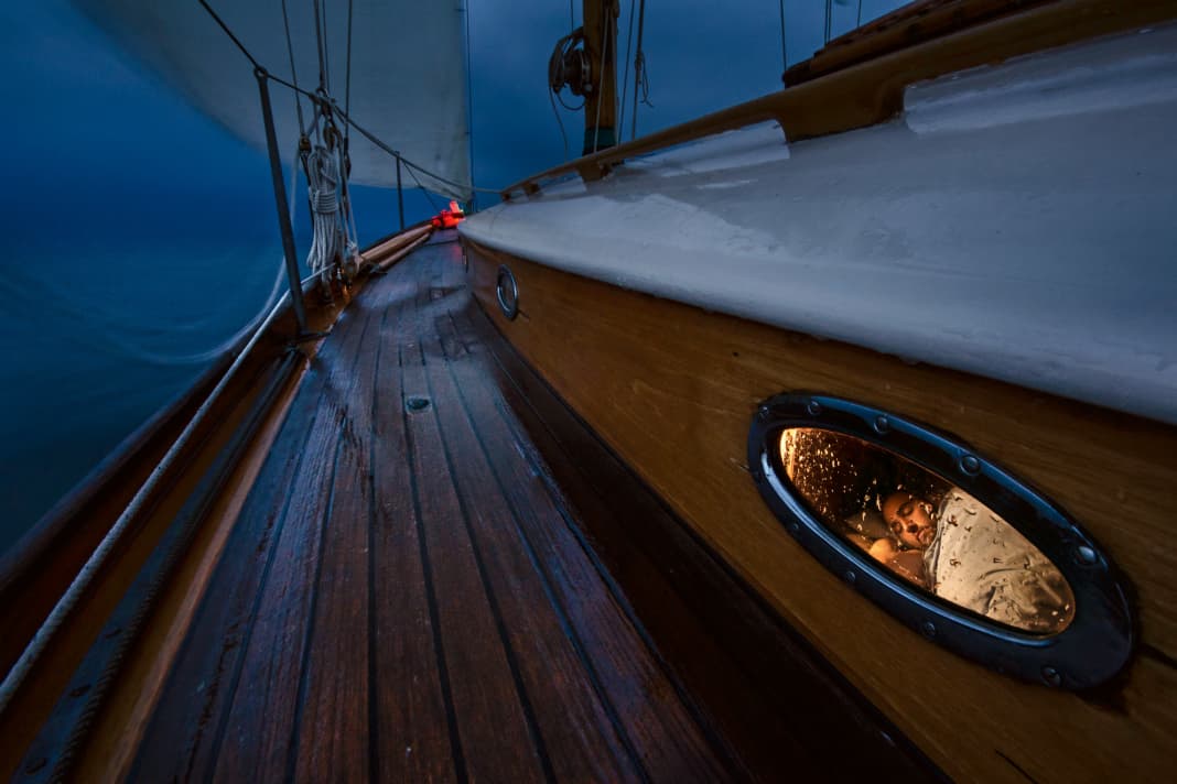 Sweet dreams. While a sailor steers the boat through the night, the free watch sleeps peacefully below deck