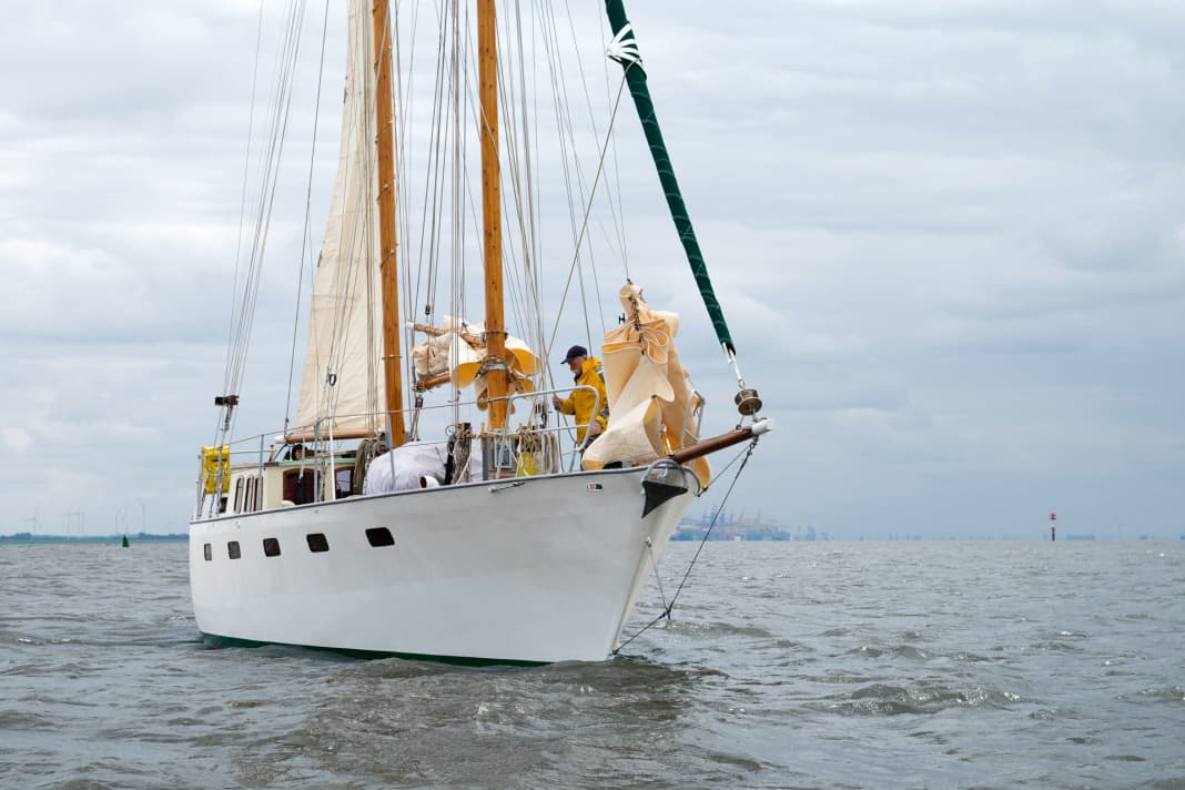 The owner built the schooner rig from wood to match the clipper bow. The high hull with the flat deckhouse looks indestructible and seaworthy