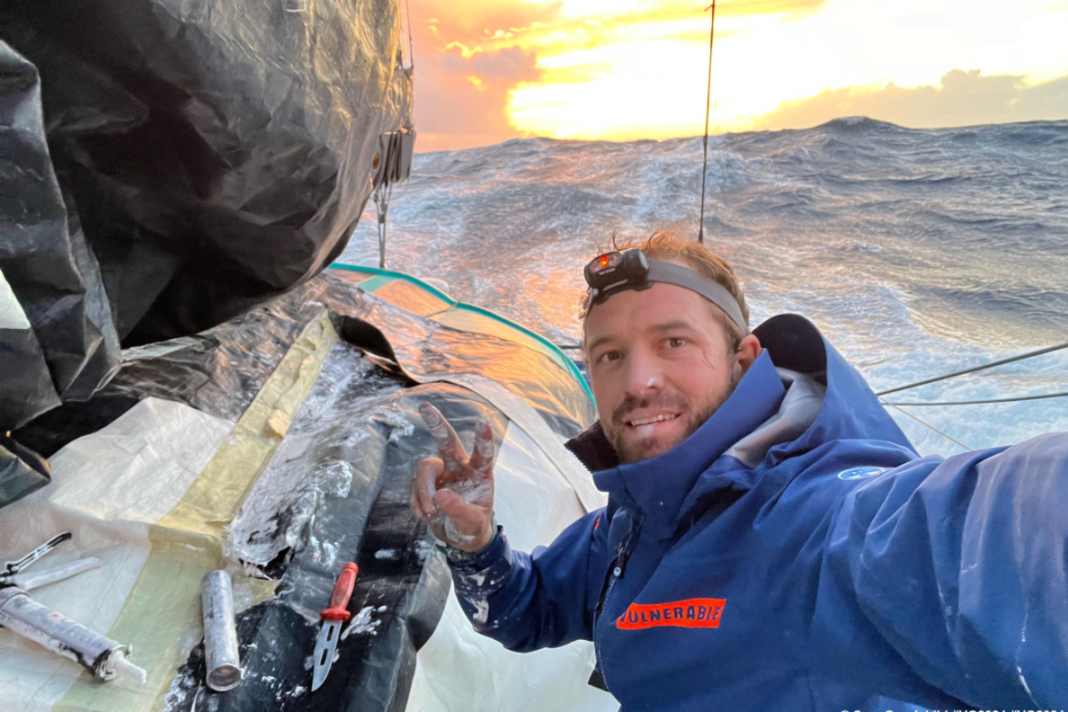 Sam Goodchild has started trying to repair his mainsail, which was torn at the third reef.