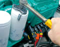 Unscrew the oil filter using a filter extractor or filter bell. Lubricate the sealing surface before fitting the new filter.