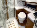 The wet room is equipped with an electric WC, a large shower and a surprising amount of storage space