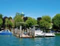 On the north bank in Allensbach, the baroque onion dome of St Nicholas' Church peeps above the treetops. A small jetty in front of it