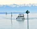 The snow-covered Allgäu Alps in the background: our charter boat arrives in Friedrichshafen harbour