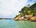 In the twin bay of Cala Algaiaren, a kind of tiny house is wedged between the rocks.
