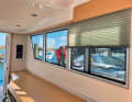 The large surface-mounted windows can be darkened using blinds.