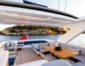 The large flybridge offers plenty of space, comfortable sofas in the stern and an area with a teak table, ...