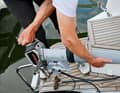 1: When the electric motor is not in use, it can be stored backwards on the rear platform in a wooden holder.