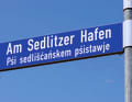 Pioneering: the street is already named after the harbour, which is still being built here. The bilingual street sign is a reminder of the Lower Sorbian settlement history.