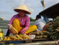 Frisch für die Touristen:  Auf einem der schwimmenden Märkte im Mekong-Delta schneidet eine Händlerin Ananas für den Verkauf.