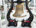 The ship's bell on the forecastle of the full-rigged ship.