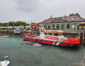 The fire brigade boat and the damaged motorboat are moored in the harbour.