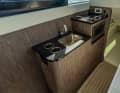 The galley was integrated on board the narrow catamaran opposite the steering position