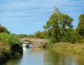 Inland trip with typical arched bridge on the Canal du Midi