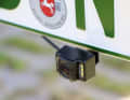 The camera is glued to a bracket behind the licence plate. It must be positioned in the centre
