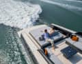 An electronically steerable bathing platform including garage awaits at the stern