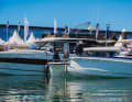 Visitors view a motor yacht at the jetties during the Ancora Yacht Festival in Neustadt.