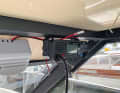 The necessary cables for the 12 V power supply and a 10 A fuse are included with the radio. We connected the device in parallel to the navigation electronics and pulled the cable through a channel under the ceiling. We glued the GPS antenna to the windscreen