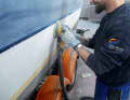 Step 2: All gelcoat surfaces are sanded with an eccentric sanding machine until the surface looks matt