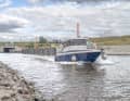 A motorboat is heading out of the Ilse Canal onto Lake Großräschen. The artificial waterway provides a navigable link to Lake Sedlitz.