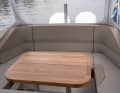 The large and well-made teak table serves as a cockpit table in the rear of the T9