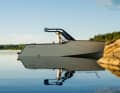 The X Shore 1 moored to a rock in the Swedish archipelago. The clear lines of the hull are clearly visible