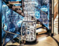 Staircase tam-tam: the owner wanted glamour and the sea. Jellyfish glow on PVC panels, metal rings shine in the open cylinder