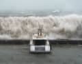 Wind-swept and bleak. Waves crash against the walls of the Port Olympic Marina in Barcelona.