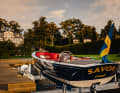 An electric or petrol outboard motor hangs under the aft peak flap.
