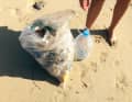 Take care of the environment: Pick up litter on your summer holiday by the sea.