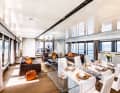 Flooded with light: Floor-to-ceiling windows and the orange accent typical of Wider characterise the large saloon on the main deck