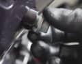 Loosen the oil drain plug and unscrew it. Place an oil collection tray underneath.