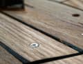 Screws that are not recessed deep enough are also exposed during sanding. They damage the paper and have to be removed. If they do not come loose, a hammer blow or heating with a soldering iron will help