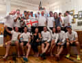 The crew of the "Ammonite" at the victory celebration with a flag of the Pacific state of Tonga