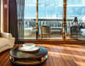 One saloon, three compartments: The TV monitor with two fireplaces separates the lounge aft from the dining area forward on the main deck.