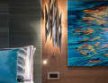 Subtle splashes of colour: only cushions and the artwork of Guernsey-based painter Valerie Travers provide accents.