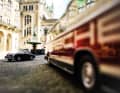 Schick von Schuco: Im Innenhof des Hamburger Rathauses spiegelt sich ein Porsche 356 A Coupé im Lack des Neoplan-Busses FH11 »Porsche Renndienst«. Der Maßstab 1:43 scheint aufgehoben zu sein. Wir sind in der Zeit zurückversetzt etwa in das Jahr 1955.
