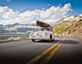 Jeff Zwart, Regie-Legende und Pikes-Peak-Gewinner, am Steuer seines Porsche 356 auf dem Independence Pass im US-Bundesstaat Colorado. Auf dem Dach ein Kanu, auf der Rückbank Berner Sennenhündin Jezzebel.