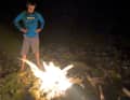 Campfire on the ghetto beach. The night covers the creepy backdrop.