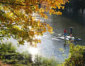 Sunny autumn days are particularly suitable for SUP tours on the Ruhr. There is practically no traffic on the river and the surrounding hills glow in the most magnificent colours, as here at the entry point on Lake Hengstey.