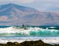 Close enough to touch: if you slice the waves at Fuerteventura's Rocky Point, the volcanic landscape of Lanzarote is always at your back.