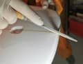 The wooden "stringer" in the centre is worked on with a small file