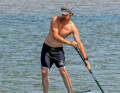 During turns, the leg on the paddle side is used more.