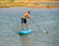 With a slight twist of the wrist, point the hollow side of the blade towards you (the curved side outwards) and dip the blade into the water at the front side of the board as cleanly as possible, i.e. without splashing